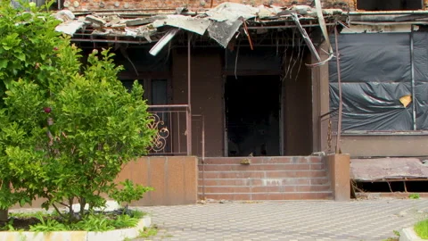 Damage to a house a year after the missile attack, Irpin, Ukraine Stock Footage 246860656