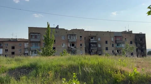 Damaged and burnt out multi-storey houses in spring time. Stock Footage 233920236