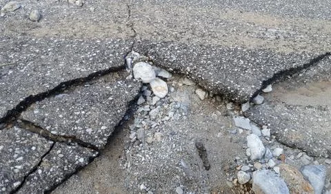 Damaged asphalt road Stock Photos
