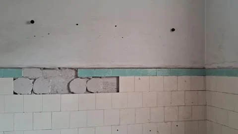 Damaged bathroom wall undergoing interior renovation Stock Footage 345362170