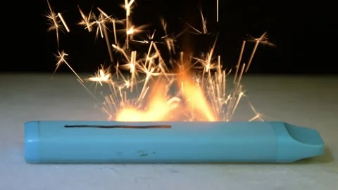 The damaged battery of an electronic cigarette suddenly ignites, and sparks fly  Stock Footage 323141276