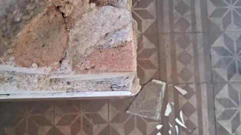 Damaged brick wall corner structure showing active construction renovation Stock Footage 337897044