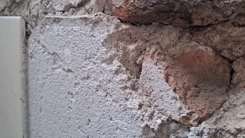 Damaged brick wall showing crumbling cement texture Stock Footage 345362182