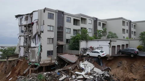 A damaged building after storm caused ground to collapse. Stock Footage 200124357