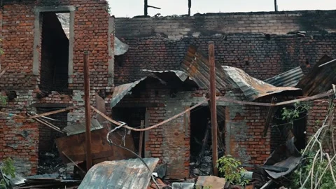 The damaged building shows charred walls and fallen debris after a fire. The Stock Footage 339095957