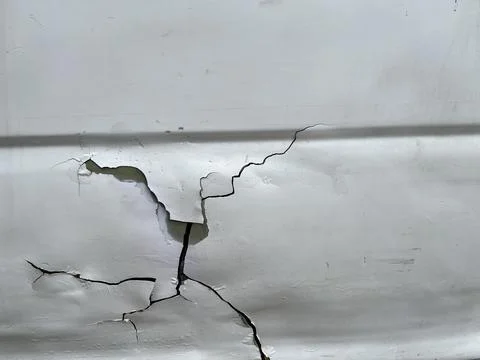 Damaged car because of accident with dent and cracked surface Stock Photos