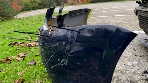 Damaged car bumper secured with zip ties after front-end collision. Stock Footage 290864381
