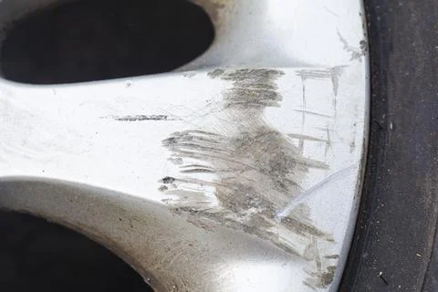 Damaged car wheel disk. Scratch and dirty aluminium wheel rim. Requiring auto Stock-Fotos