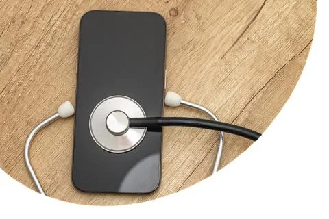 A damaged cell phone with a black screen turned off is placed on a wooden s.. Stock Photos