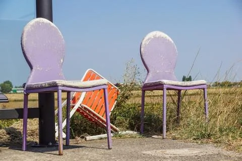 Damaged chairs at the bus stop, close-up, background image Stock Photos