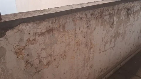 Damaged concrete wall structure showcasing weathered texture in motion video Stock Footage 339302072