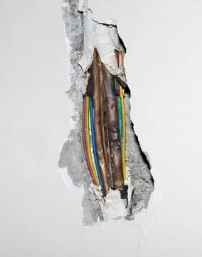 Damaged copper pipe in a wall Stock Photos