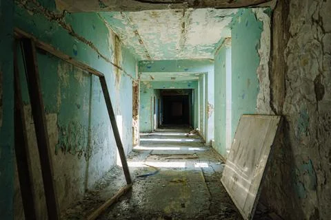 Damaged corridor in an abandoned building Stock Photos