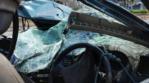 Damaged destroyed car front window broken glass accident Stock Photos