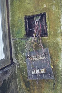 Damaged electrical switch board in old building Stock Photos