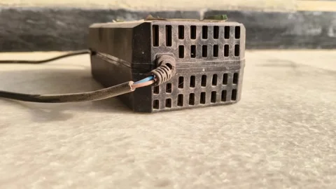 Damaged electrical wires with exposed copper cores in a black insulation sleeve Video stock 327572818