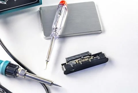 Damaged external drive SSD HDD , transformer soldering iron on white backgr.. Stock Photos