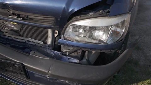 Damaged front of a dark blue car after a collision Stock Footage 344811088