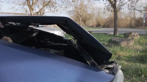 Damaged front of a dark blue car after a collision Stock Footage 344811104
