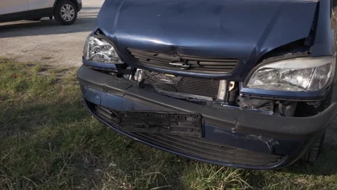 Damaged front of a dark blue Opel car after a collision Stock Footage 344810972