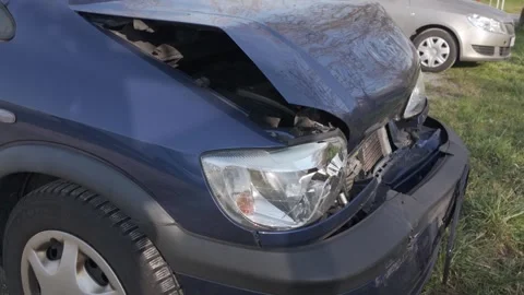 Damaged front of a dark blue Opel car after a collision Stock Footage 344811131