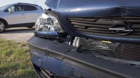 Damaged front of a dark blue Opel car after a collision Stock Footage 344811188