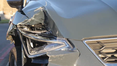 Damaged front of a silver car after collision in close up view. Stock Footage 297124468
