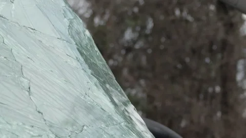 Damaged front windshield glass on smashed car 4k Stock Footage 332955703