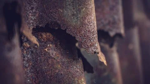 Damaged galvanized iron sheet wall on old warehouse. Detail view of old rusty Stock Photos