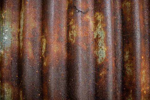 Damaged galvanized iron sheet wall on old warehouse. Detail view of old rusty Stock Photos