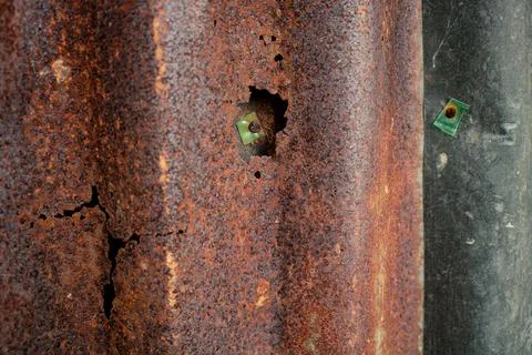 Damaged galvanized iron sheet wall on old warehouse. Detail view of old rusty Stock Photos