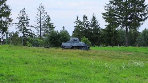 A damaged German tank of the Second World War on a field against the backdrop of Stock Footage 297255216