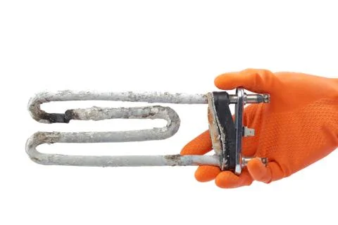 Damaged heating element of the washing machine in hand. Stock Photos