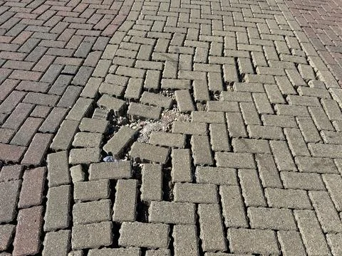 Damaged Interlocking Brick Pavers Pattern With Loose Gravel Stock Photos
