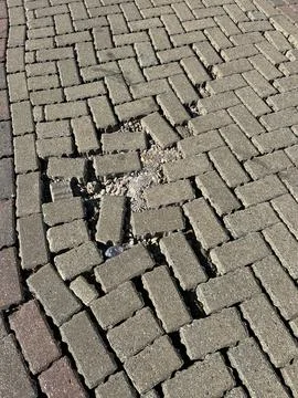 Damaged Interlocking Brick Pavers Pattern With Loose Gravel Stock Photos