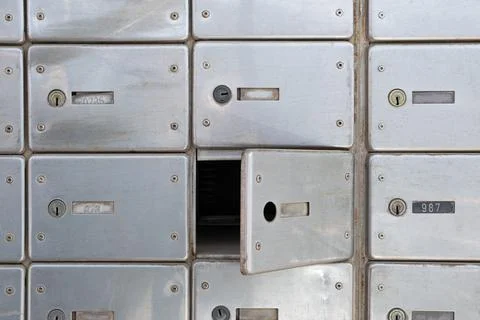 Damaged lock P.O Mailbox hack in the Post Office. Rows of aged mailboxes with Stock Photos