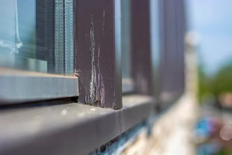 Damaged modern window frames in bad condition that need to be refurbished and Stock Photos