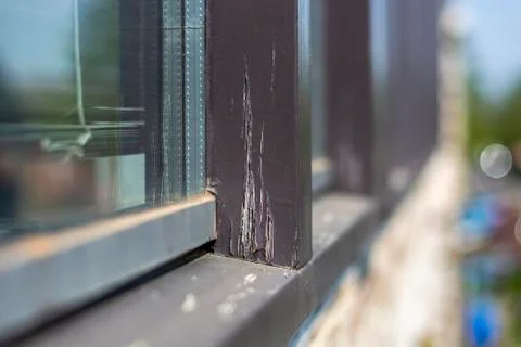 Damaged modern window frames in bad condition that need to be refurbished and Stock Photos