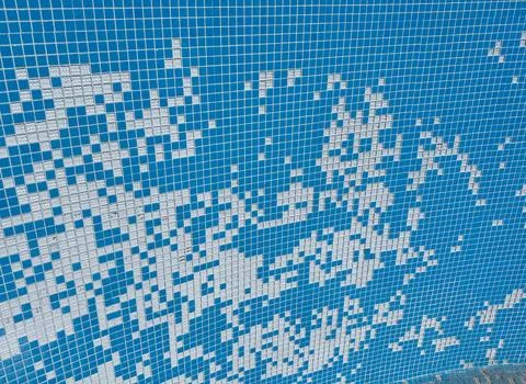 Damaged mosaic tiles falling into empty swimming pool preparations for renova Stock Photos