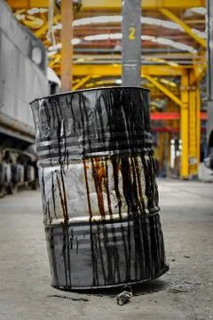 Damaged oil drums in industrial interior Stock Photos