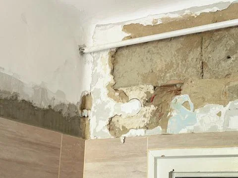 Damaged Old Interior Wall,  Peeling Paint and Exposed Plaster During Renovation Stock Photos