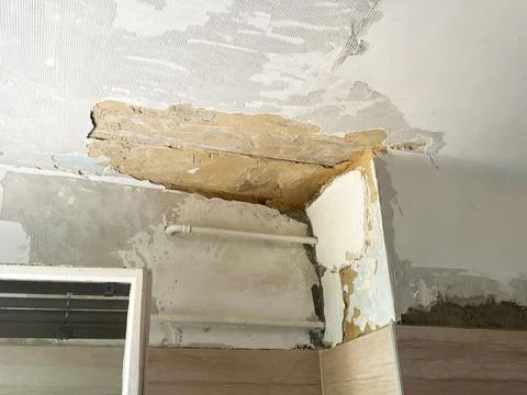 Damaged Old Wall with Peeling Paint and Exposed Plaster During Renovation Stock Photos