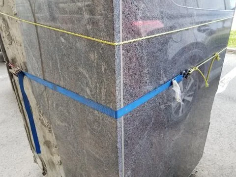Damaged or worn stone or cement pillar or column with rope Stock Photos