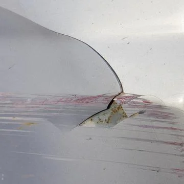 Damaged paintwork on the rear of the car, initial stage of wing corrosion Stock Photos
