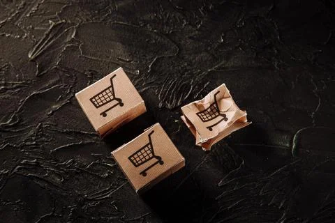 Damaged paper box on a grey background. Delivery concept Stock Photos