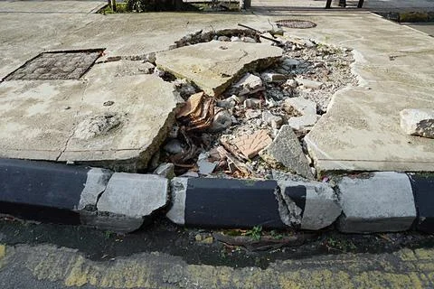 Damaged pedestrian path. Broken and dangerous for users Stock Photos