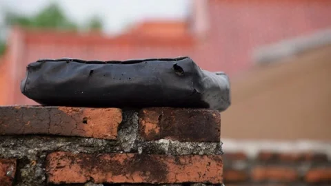 Damaged pillows on brick wall rooftop with residential background in Indonesi Stock Footage 312055961