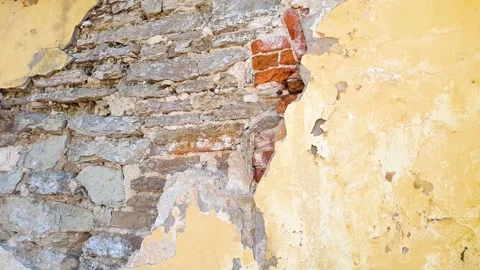 A damaged plastered wall. A hole in the plaster; restoration and repair of walls Stock Footage 343874462