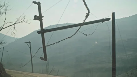 Damaged power lines after a devastating wildfire Stockbeeldmateriaal 332963125