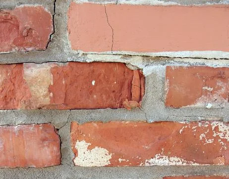 Damaged Red Brick Wall Texture: Cracked and Peeling Surface, Rustic Background Stock Photos